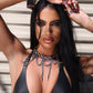 Woman wearing a black leather outfit with stainless steel choker details against a neutral background