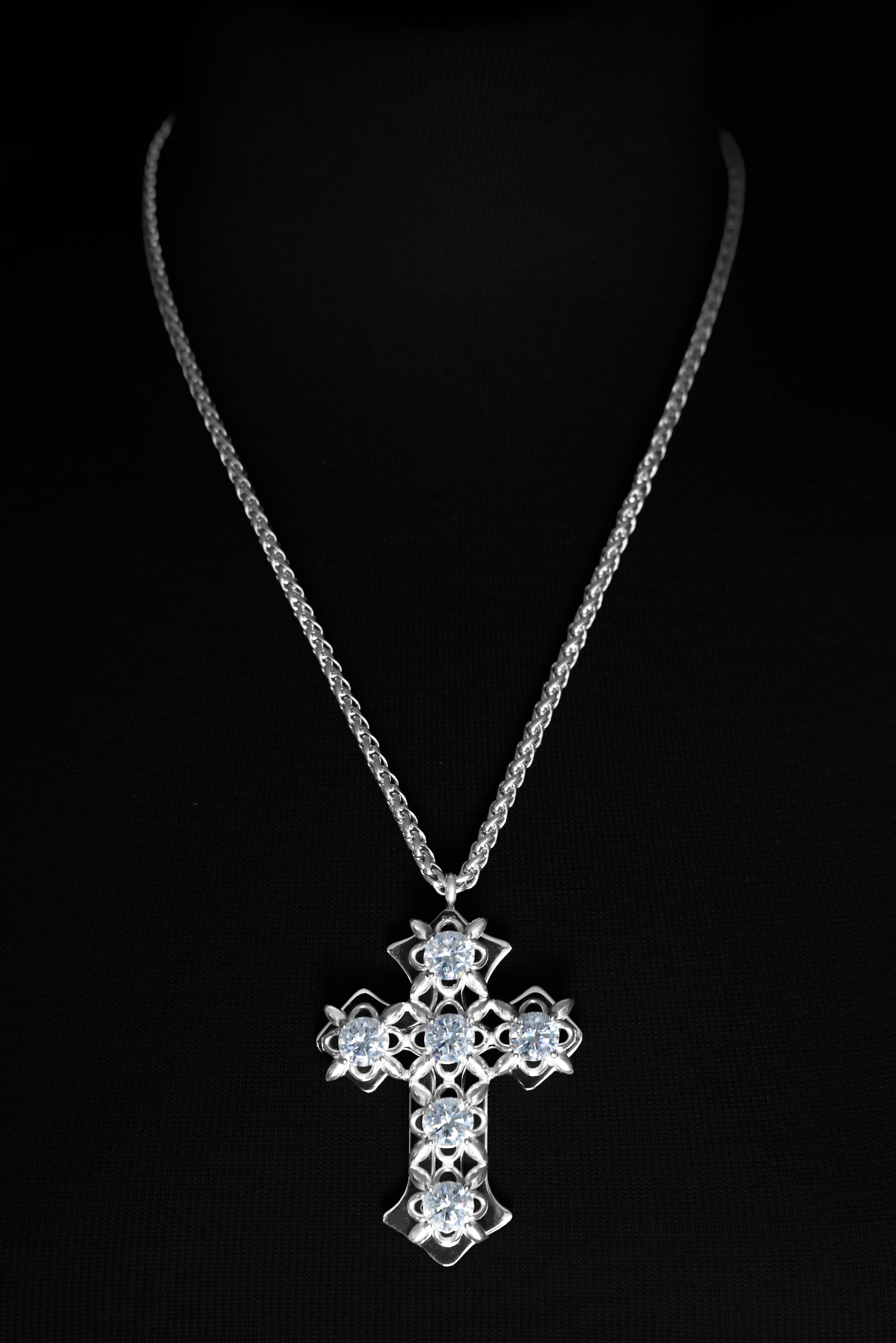 Stainless steel cross necklace on a black background