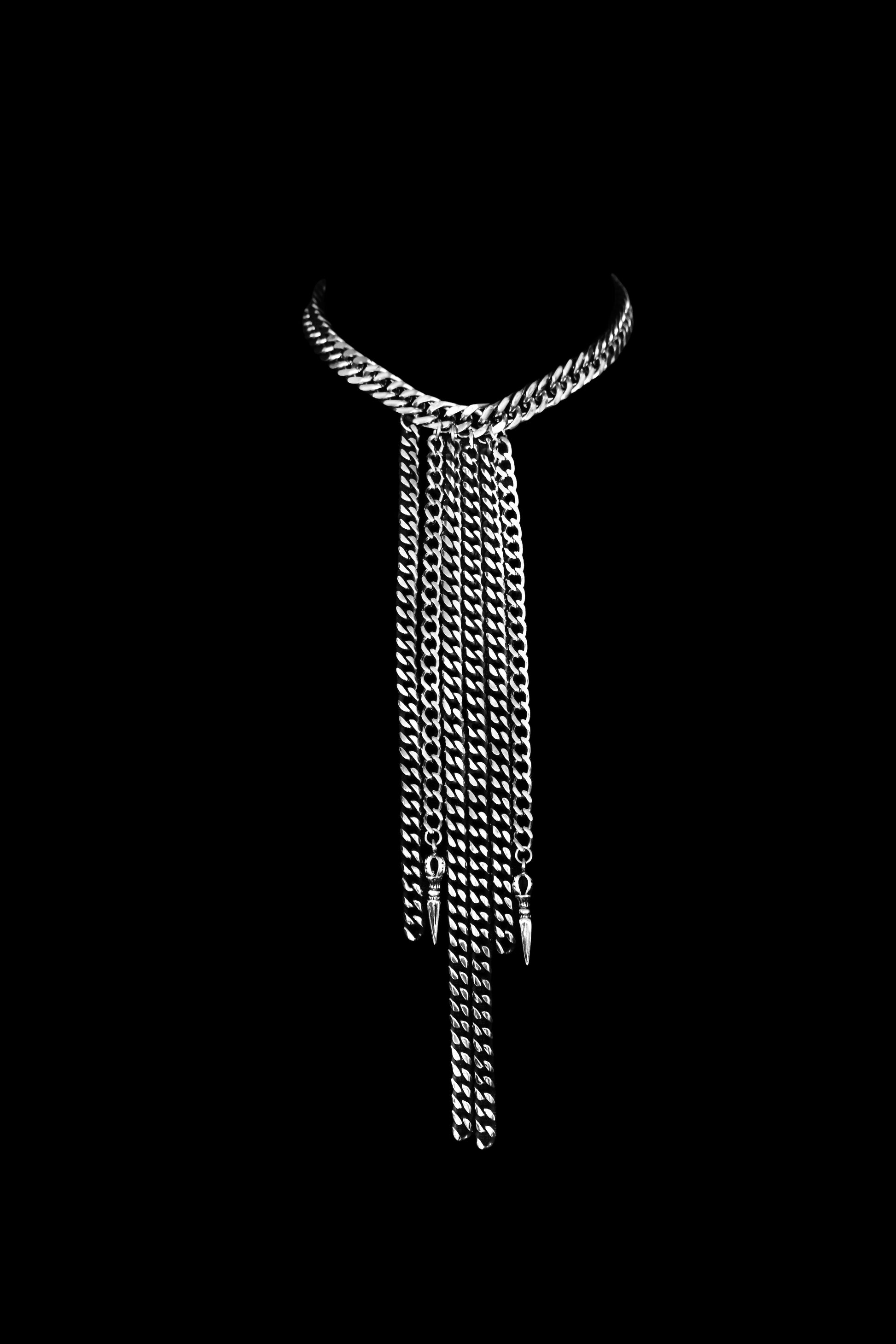 Silver chain necklace on a black background